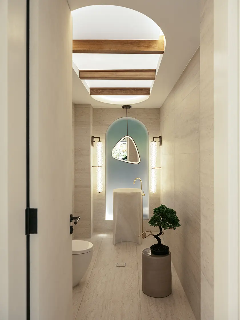 Nina Maya Interiors_FAIRFAX-219-Edit Arched stone corridor with pendant lighting and a freestanding basin
